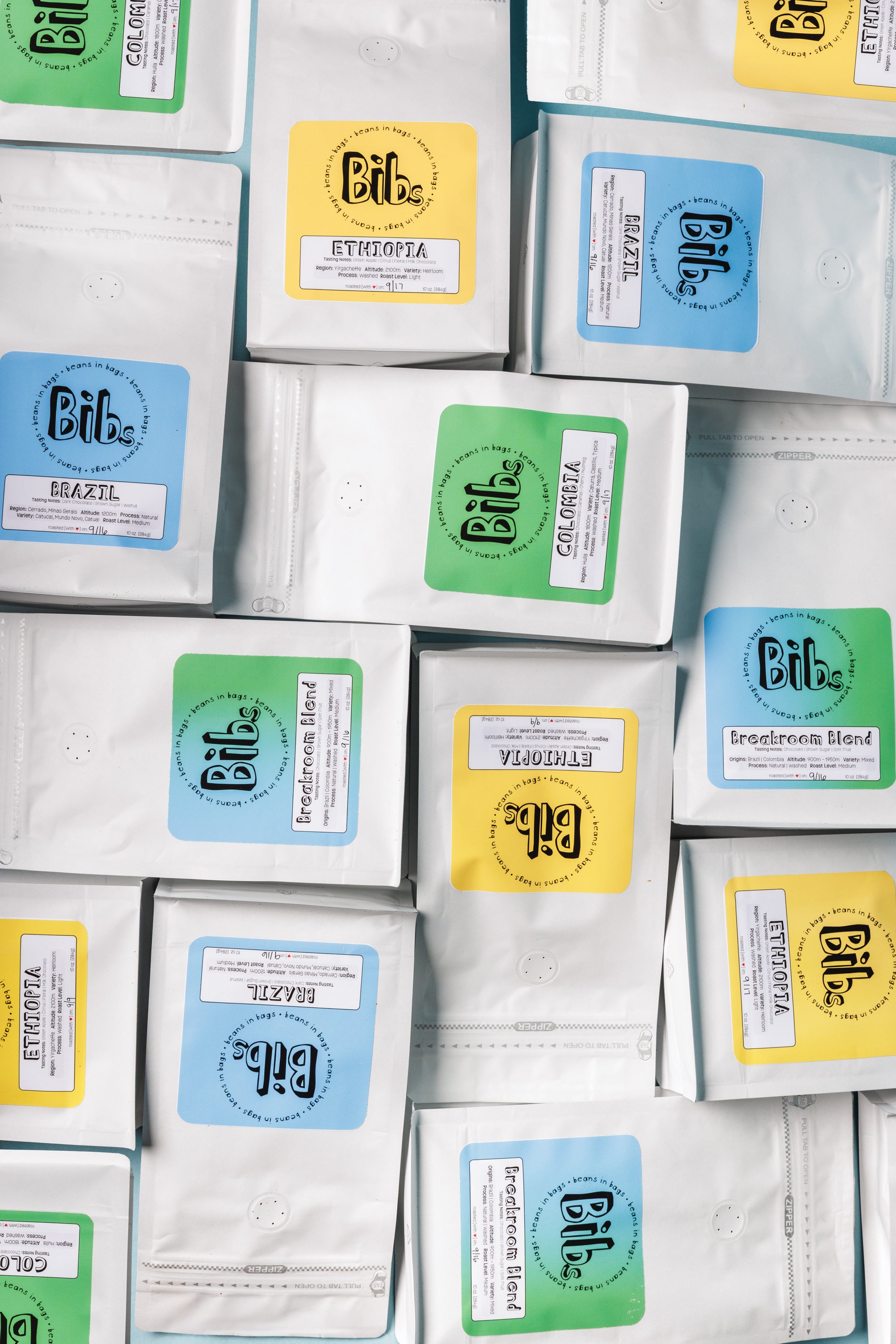 Collection of coffee bags with various labels on a white background