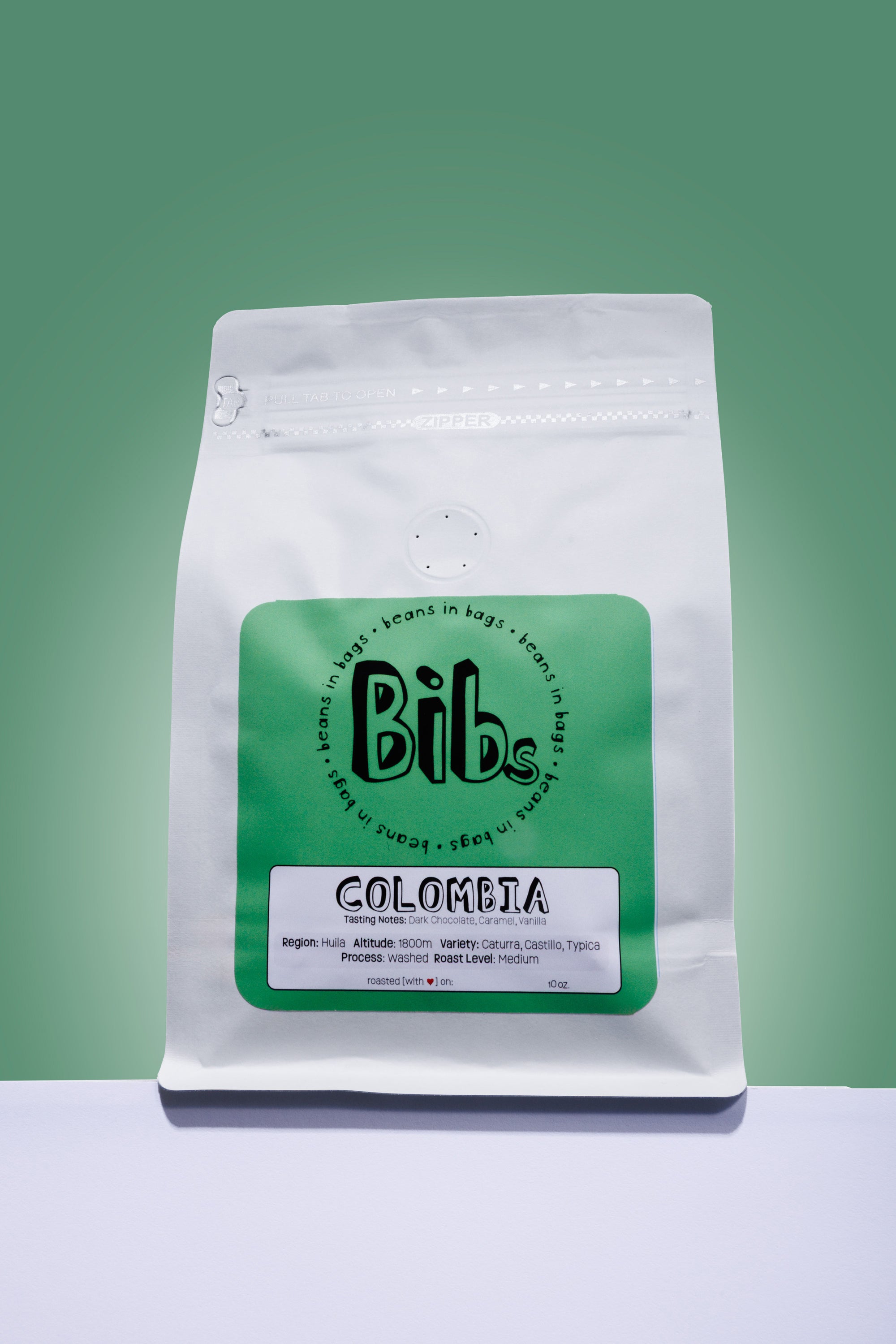Coffee bag labeled 'Bibs' with 'Colombia' on a green background