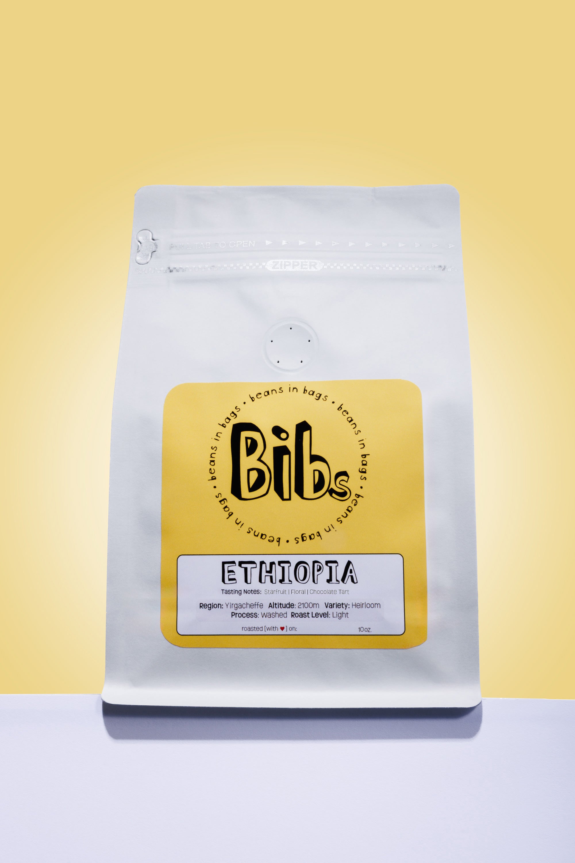 Coffee bag with 'Bibs' branding on a yellow background